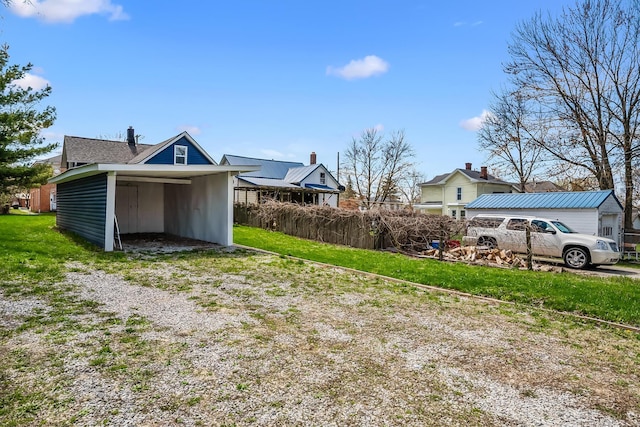 view of yard with a carport and driveway