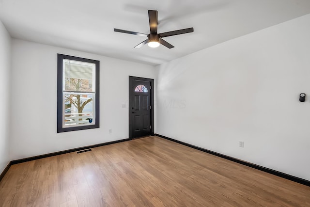 entryway featuring visible vents, baseboards, a ceiling fan, and wood finished floors