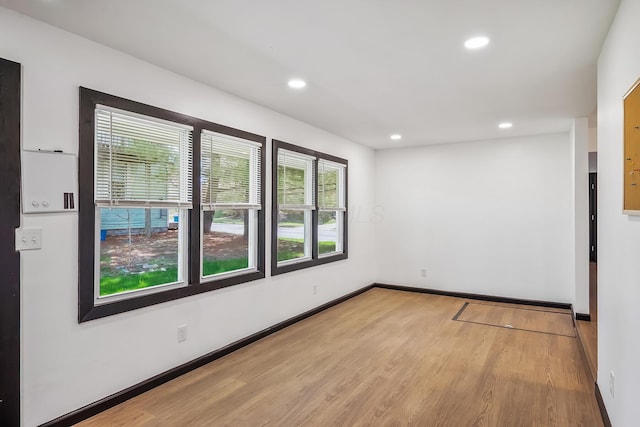 unfurnished room featuring recessed lighting, baseboards, and wood finished floors