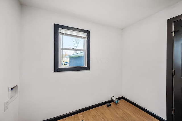 empty room featuring baseboards and wood finished floors