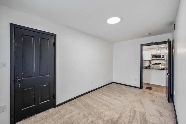 interior space with visible vents, baseboards, and carpet