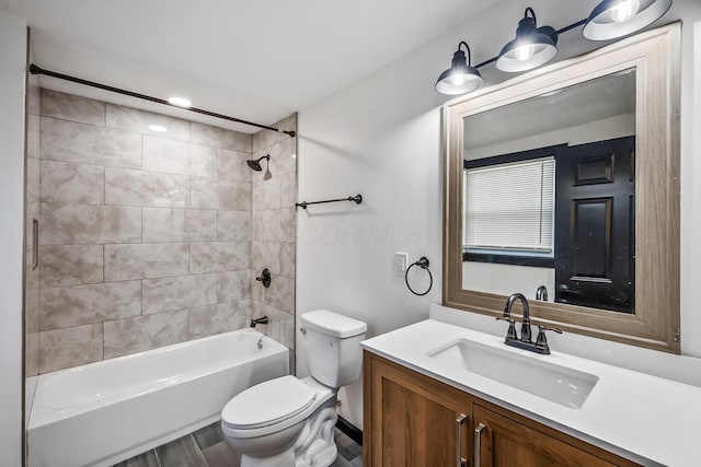 full bathroom with washtub / shower combination, toilet, and vanity