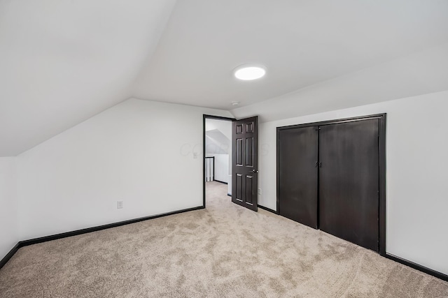 bonus room featuring carpet flooring, baseboards, and lofted ceiling