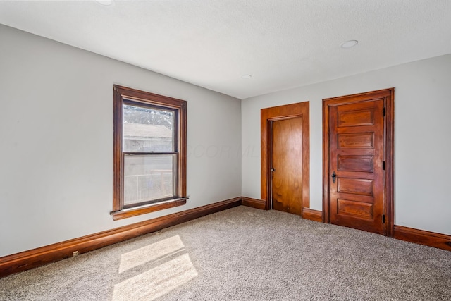 593 N State St, Marion, OH 43302 - unfurnished bedroom with carpet flooring, baseboards, and a textured ceiling