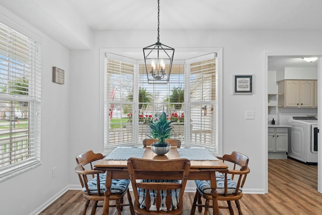 508 Straiton Sq, Westerville, OH 43082 - dining area featuring a chandelier, baseboards, light wood-style flooring, and washer / dryer