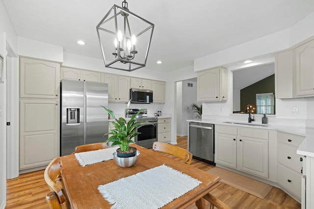 508 Straiton Sq, Westerville, OH 43082 - kitchen featuring a sink, light wood-style flooring, appliances with stainless steel finishes, and an inviting chandelier