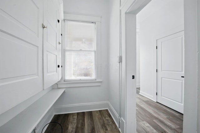 hall featuring baseboards and wood finished floors