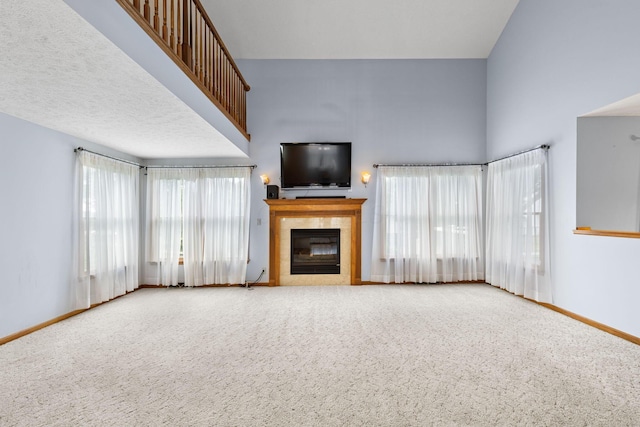 2816 Quail Run Ct, Mansfield, OH 44904 - unfurnished living room with a fireplace, carpet flooring, and a towering ceiling