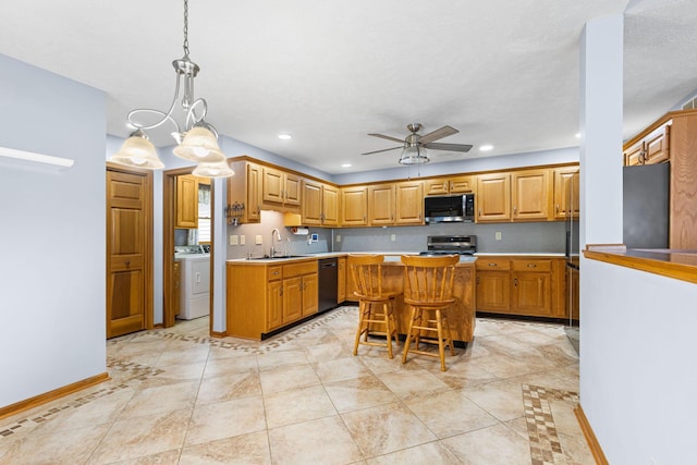 2816 Quail Run Ct, Mansfield, OH 44904 - kitchen with black dishwasher, stainless steel range, ceiling fan, a kitchen island, and light countertops