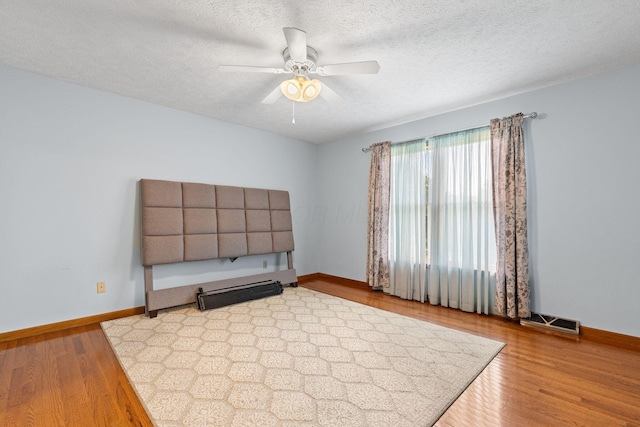 2816 Quail Run Ct, Mansfield, OH 44904 - unfurnished room featuring wood finished floors, ceiling fan, and a textured ceiling