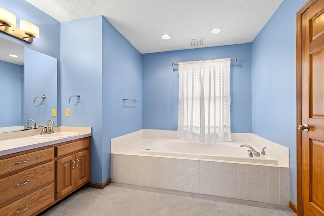 2816 Quail Run Ct, Mansfield, OH 44904 - full bathroom with vanity, a bath, a textured ceiling, and recessed lighting