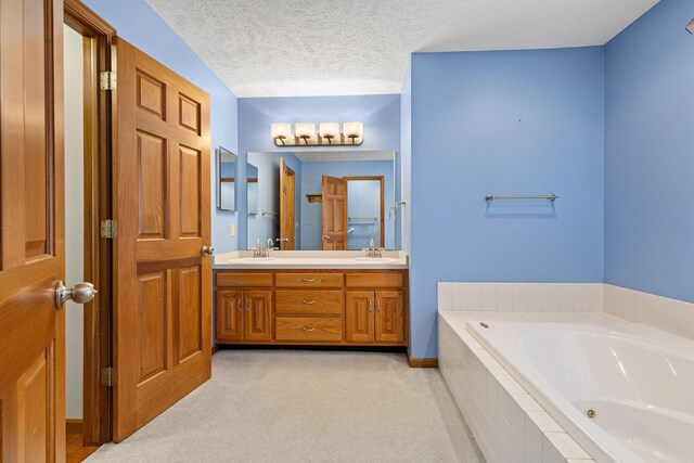 2816 Quail Run Ct, Mansfield, OH 44904 - full bathroom with double vanity, a jetted tub, and a textured ceiling
