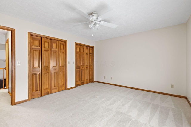 2816 Quail Run Ct, Mansfield, OH 44904 - unfurnished bedroom featuring light carpet, multiple closets, and a ceiling fan
