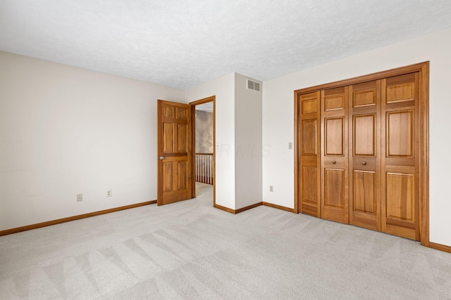 2816 Quail Run Ct, Mansfield, OH 44904 - unfurnished bedroom featuring light colored carpet, a textured ceiling, and a closet