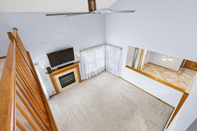 2816 Quail Run Ct, Mansfield, OH 44904 - unfurnished living room featuring a ceiling fan, a glass covered fireplace, and carpet floors