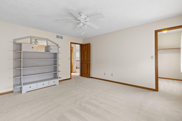 2816 Quail Run Ct, Mansfield, OH 44904 - unfurnished bedroom with carpet, a walk in closet, ceiling fan, and a closet