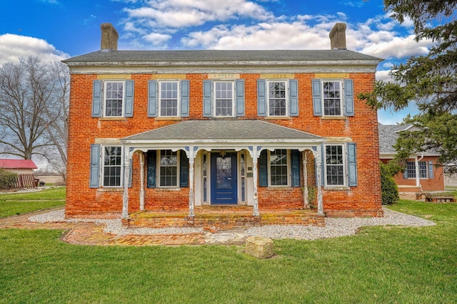 2085 US Highway 62 NE, Washington Court House, OH 43160 - view of front facade featuring a chimney, a front yard, brick siding, roof with shingles, and a porch