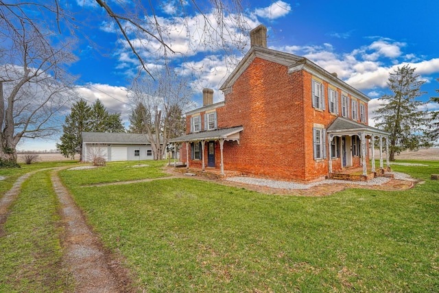 2085 US Highway 62 NE, Washington Court House, OH 43160 - view of property exterior with an outdoor structure, brick siding, a yard, and a chimney