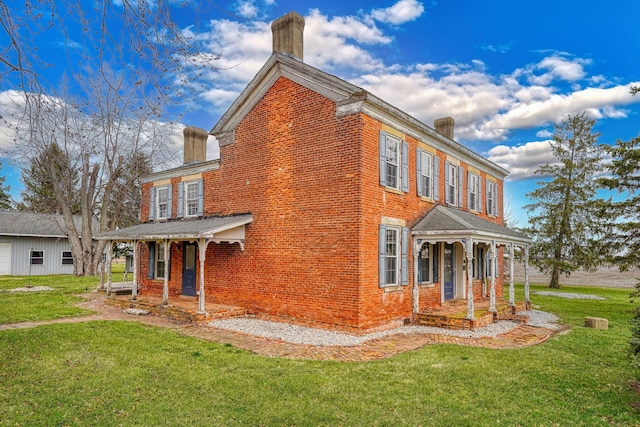 2085 US Highway 62 NE, Washington Court House, OH 43160 - view of side of property with brick siding, a porch, a lawn, and a chimney