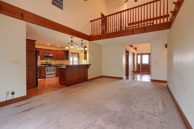 2085 US Highway 62 NE, Washington Court House, OH 43160 - unfurnished living room with light colored carpet, a high ceiling, and a healthy amount of sunlight