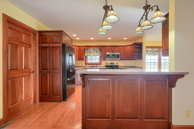 2085 US Highway 62 NE, Washington Court House, OH 43160 - kitchen featuring light countertops, visible vents, light wood-style flooring, a peninsula, and appliances with stainless steel finishes