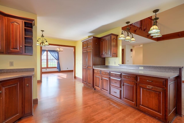 2085 US Highway 62 NE, Washington Court House, OH 43160 - kitchen with light wood finished floors, a peninsula, hanging light fixtures, and a chandelier