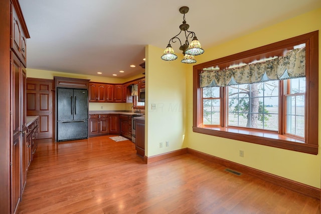 2085 US Highway 62 NE, Washington Court House, OH 43160 - kitchen with pendant lighting, stainless steel appliances, baseboards, visible vents, and light wood-style floors