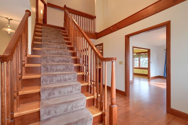 2085 US Highway 62 NE, Washington Court House, OH 43160 - stairs featuring baseboards, a towering ceiling, and wood finished floors
