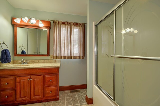 2085 US Highway 62 NE, Washington Court House, OH 43160 - bathroom with visible vents, baseboards, combined bath / shower with glass door, vanity, and tile patterned flooring