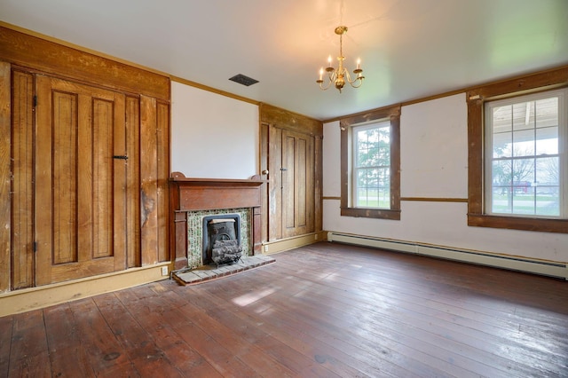 2085 US Highway 62 NE, Washington Court House, OH 43160 - unfurnished living room featuring a baseboard radiator, visible vents, a chandelier, and hardwood / wood-style flooring