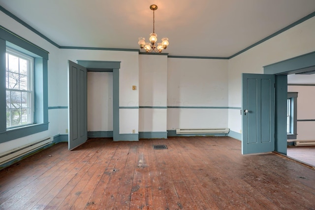 2085 US Highway 62 NE, Washington Court House, OH 43160 - spare room with crown molding, a baseboard heating unit, a notable chandelier, and hardwood / wood-style flooring
