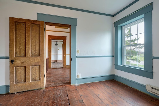 2085 US Highway 62 NE, Washington Court House, OH 43160 - unfurnished room with ornamental molding, baseboard heating, and wood-type flooring