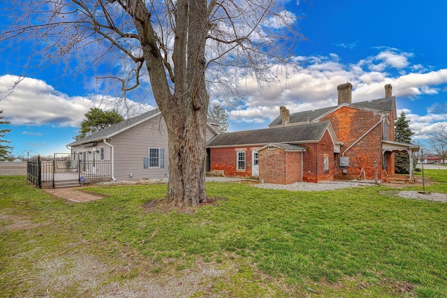 2085 US Highway 62 NE, Washington Court House, OH 43160 - back of property featuring brick siding, a lawn, fence, and a chimney
