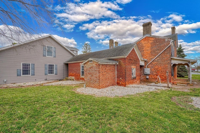 2085 US Highway 62 NE, Washington Court House, OH 43160 - back of house featuring a chimney, brick siding, and a lawn