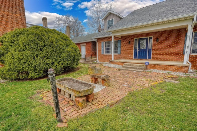 2085 US Highway 62 NE, Washington Court House, OH 43160 - exterior space featuring a front lawn, a porch, brick siding, and roof with shingles