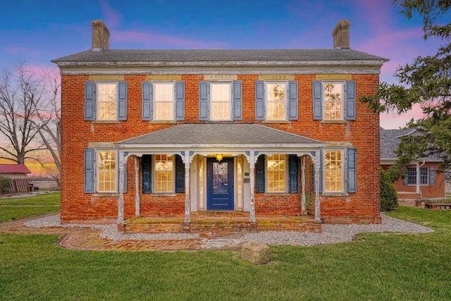 2085 US Highway 62 NE, Washington Court House, OH 43160 - view of front of house with brick siding, a shingled roof, covered porch, and a yard