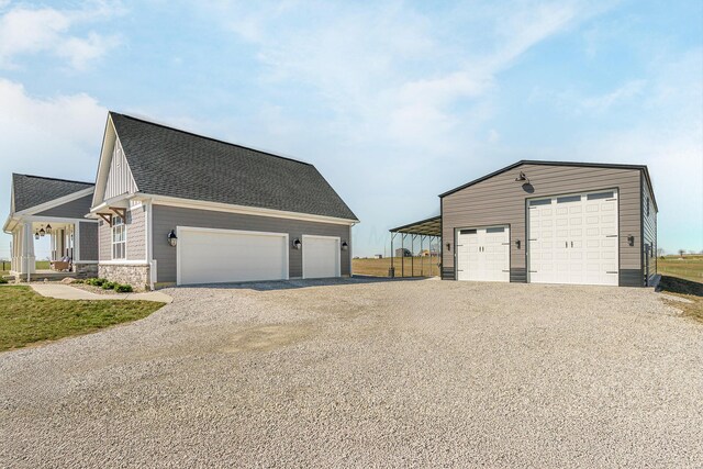 garage featuring driveway and a detached garage