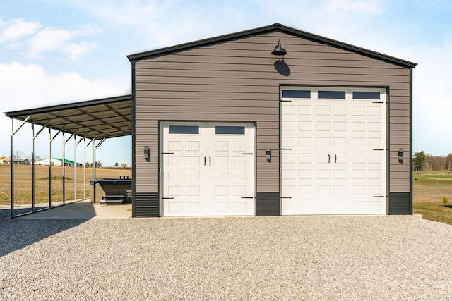 garage with a garage and gravel driveway