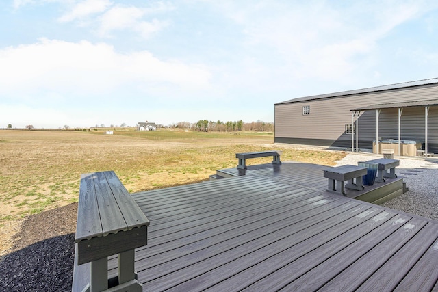 wooden terrace with a yard and a hot tub