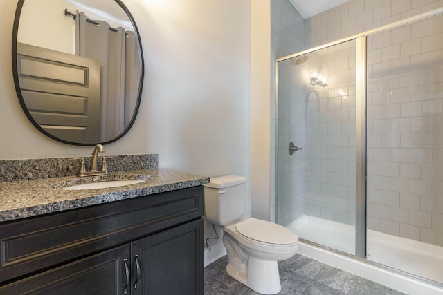 full bathroom with toilet, vanity, and a stall shower