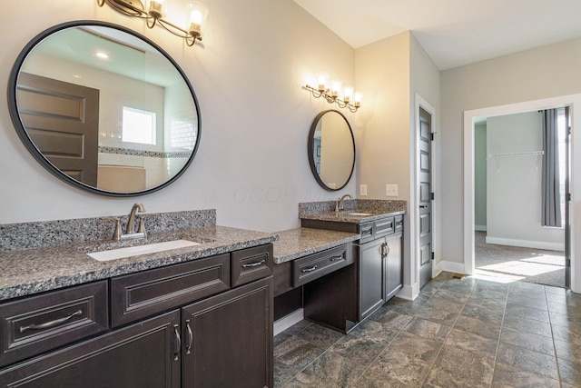 full bathroom with vanity and baseboards