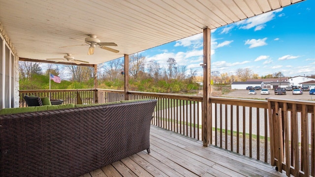 wooden terrace with a ceiling fan
