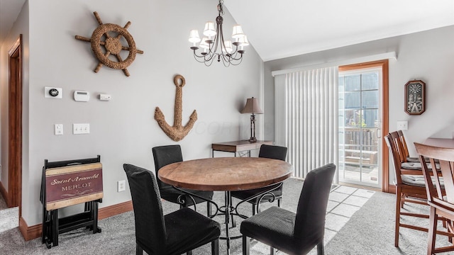 dining space featuring baseboards, lofted ceiling, an inviting chandelier, and light carpet