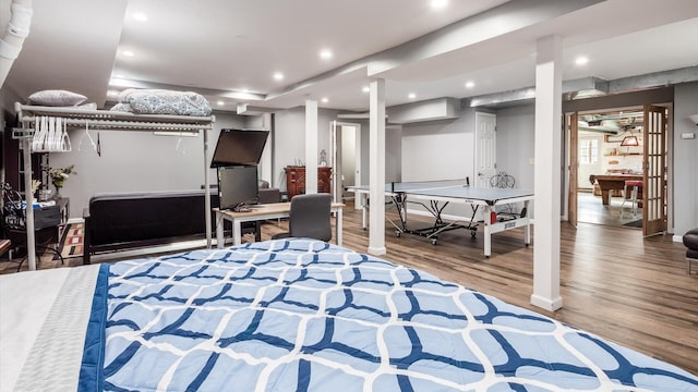 bedroom with recessed lighting and wood finished floors