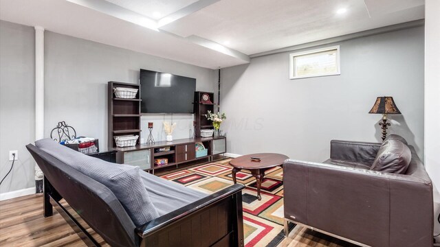 living room featuring baseboards and wood finished floors