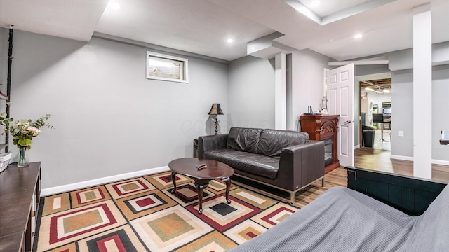 living area featuring wood finished floors, baseboards, and recessed lighting