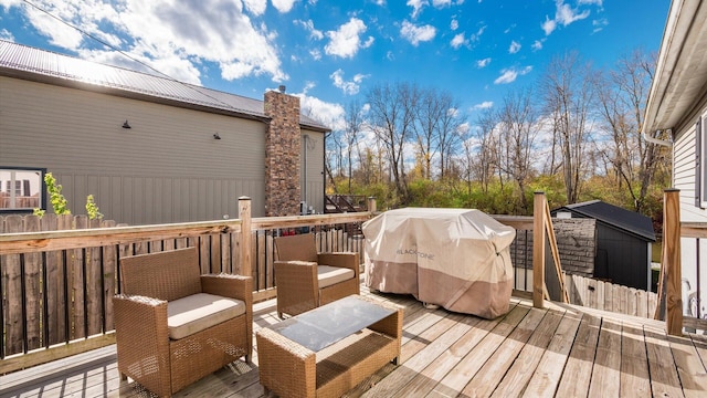 wooden deck with a grill