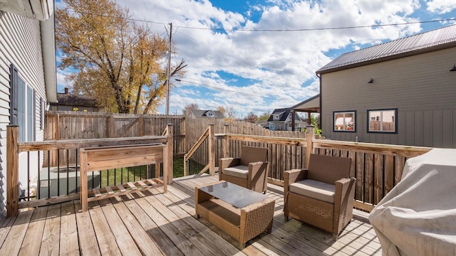 wooden deck with fence and an outdoor living space
