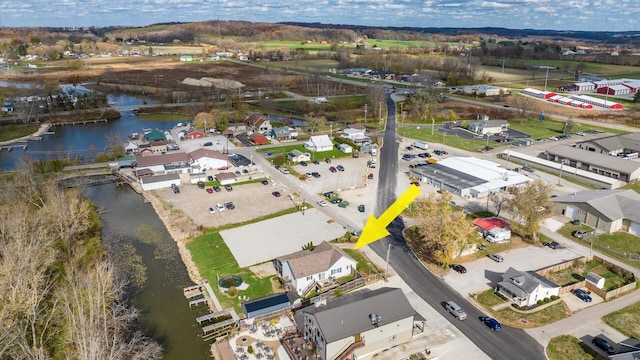 birds eye view of property featuring a water view and a residential view