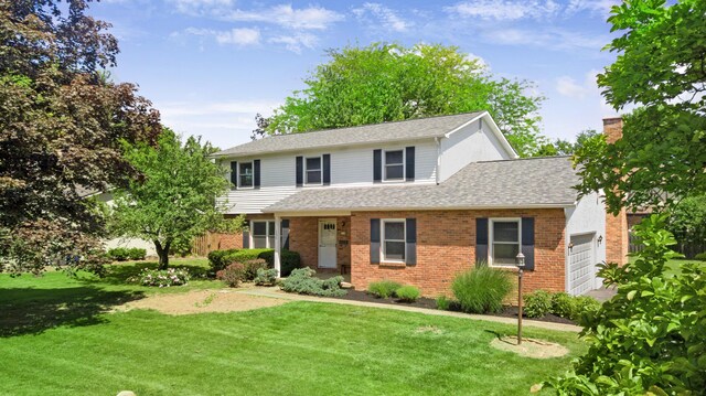 1330 Darcann Dr, Columbus, OH 43220 - traditional-style home with a garage, a front lawn, and brick siding